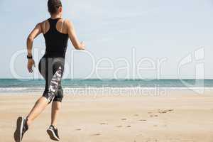 Fit woman jogging on the sand