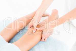 Female masseur massaging womans leg