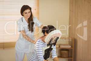 Young woman getting massage in chair