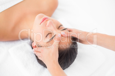 Attractive woman receiving head massage at spa center