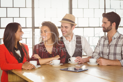 Happy friends discussing together