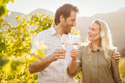 Young happy couple holding glasses of wine