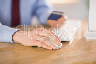 Businessman shopping online at desk