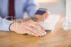 Businessman shopping online at desk