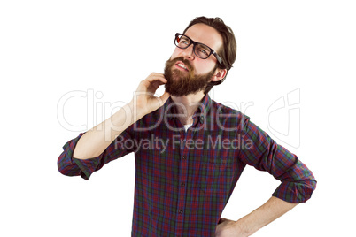 Handsome hipster thinking and scratching beard
