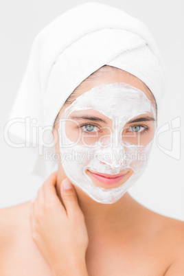 Attractive woman having white cream on her face