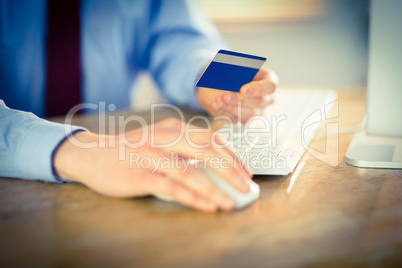 Businessman shopping online at desk