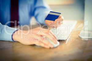 Businessman shopping online at desk