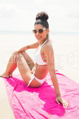 Smiling woman sunbathing on towel
