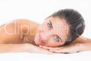 Close up portrait of a beautiful young woman on massage table