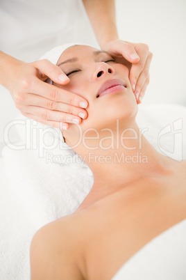 Attractive woman receiving facial massage