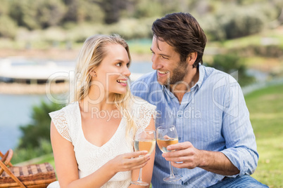 Couple toasting with glass of white wine