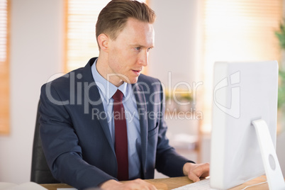 Stylish businessman working at his desk