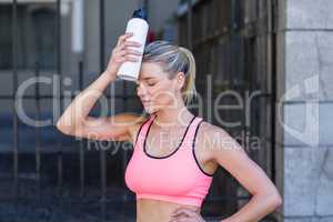 A beautiful woman holding a bottle of water