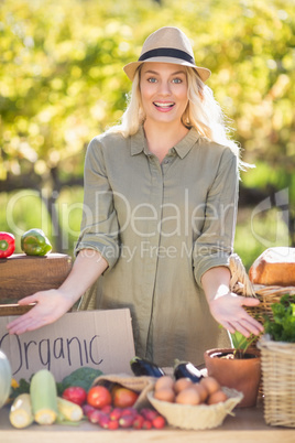 Smiling blonde presenting the table of local food