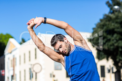 An handsome athlete stretching