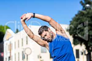 An handsome athlete stretching