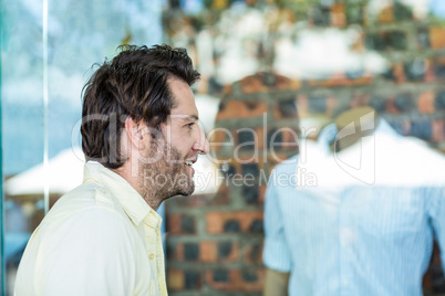 Smiling man going window shopping