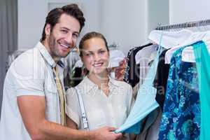 Smiling couple looking at clothes