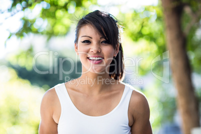 Portrait of smiling athletic woman looking at camera