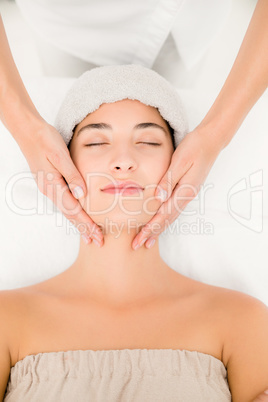 Attractive young woman receiving massage at spa center