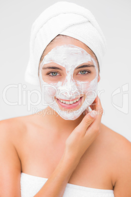 Attractive woman having white cream on her face