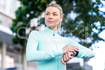 A beautiful athlete watching her watch