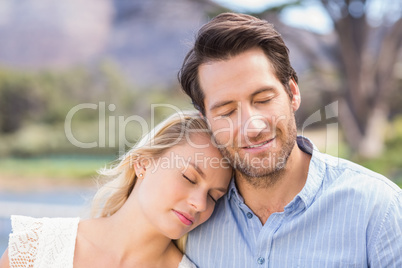 Smiling couple on date relaxing with eye closed