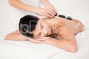 Pretty woman receiving a hot stone massage