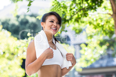 Smiling athletic woman with towel