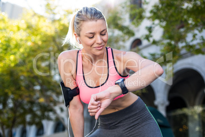 A beautiful athlete watching her watch