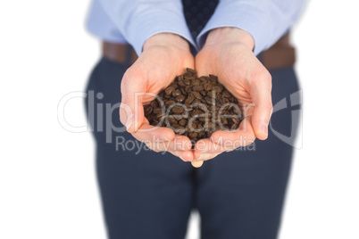 Businessman showing coffee beans