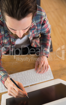 Businessman pointing at computer with pen