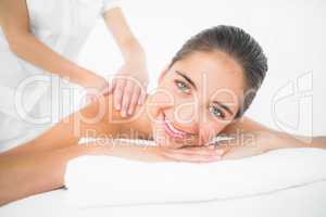 Attractive woman receiving back massage at spa center