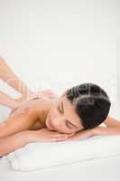 Woman enjoying a salt scrub massage