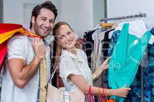 Smiling couple browsing clothes