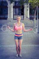 A pretty woman doing jumping rope