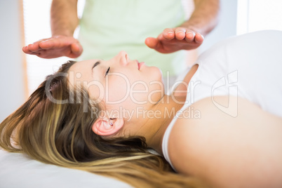 Close up view of relaxed pregnant woman getting reiki treatment Close up view of relaxed pregnant woman getting reiki treatment