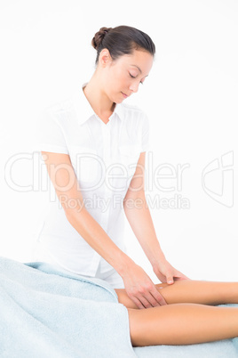 Female masseur massaging womans leg