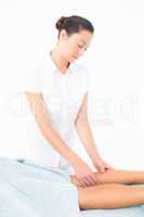 Female masseur massaging womans leg