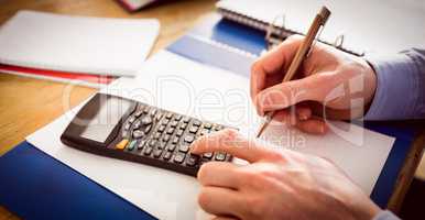 Businessman hands typing and writing