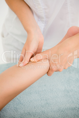 Masseur massaging womans leg