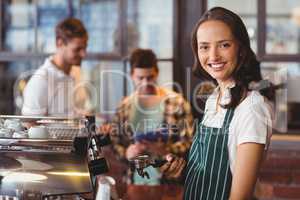 Pretty barista making a cup of coffee