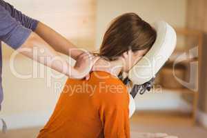 Young woman getting massage in chair