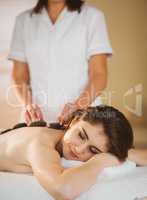 Young woman getting a hot stone massage