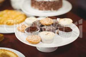 Close up plates of pastries and cupcakes