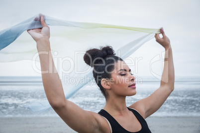 Fit girl standing with scarf blowing in wind