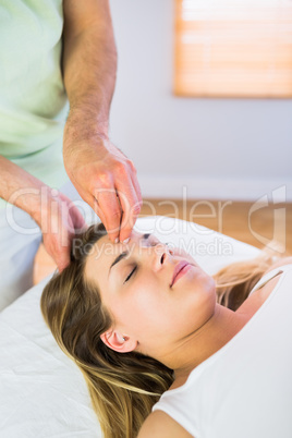 Relaxed pregnant woman enjoying head massage