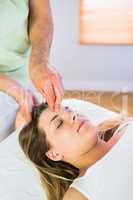 Relaxed pregnant woman enjoying head massage