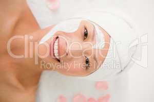 Smiling woman with cream treatment